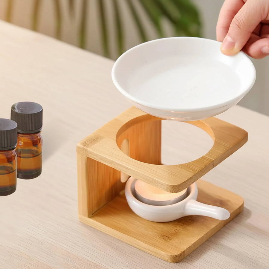 Porcelain bowl lifted off a wooden oil warmer