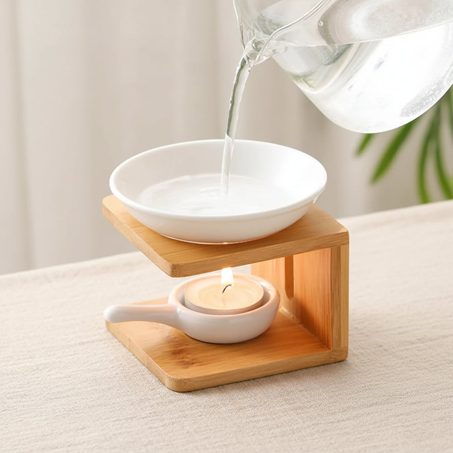Water poured into the ceramic dish of the bamboo oil warmer