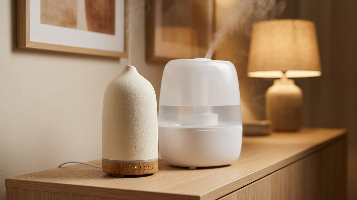 Cream wood-grain essential oil diffuser and a white tabletop humidifier side by side on an oak sideboard