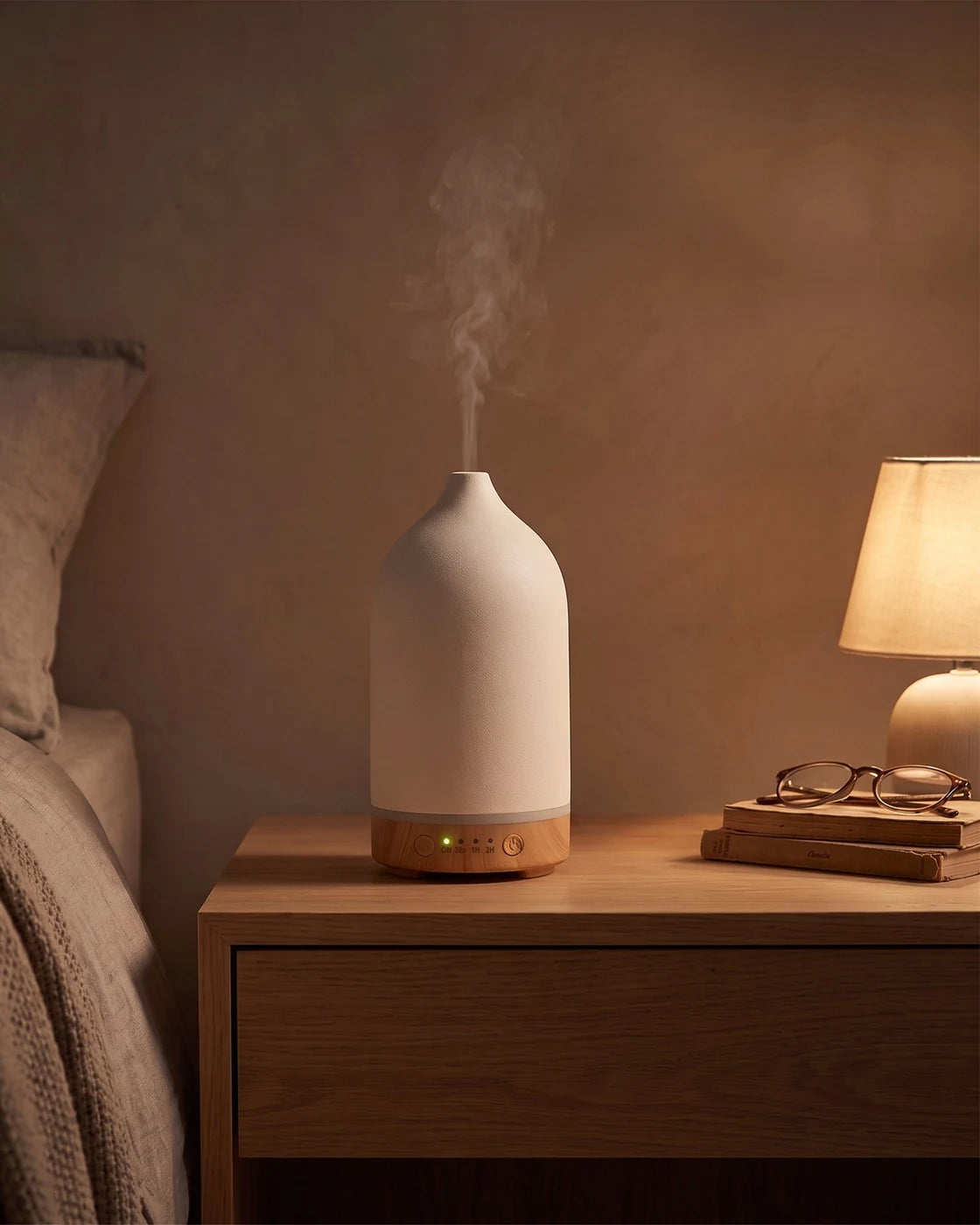 Cream wood-grain diffuser glowing in a darkened bedroom